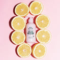 Load image into Gallery viewer, Be True Relax Smooth Repair Shampoo lay around by citrus slices