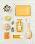 Load image into Gallery viewer, Bonheur ORANGE FLOWER Shampoo with orange color objects