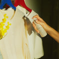 Load image into Gallery viewer, spraying Mimosa Pillow Mist to clothing
