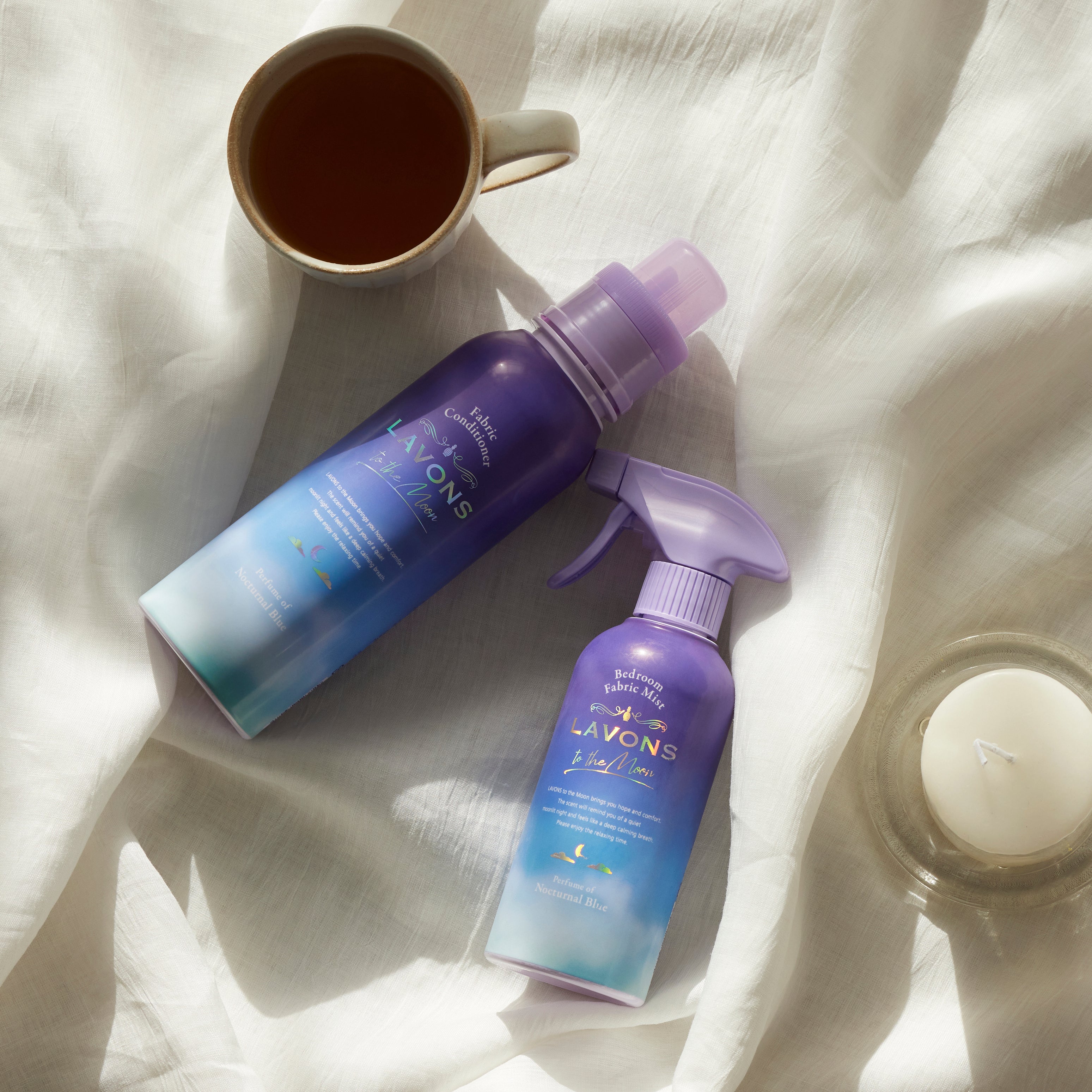 Nocturnal Blue fabric refresher & conditioner lay on white farbric platform