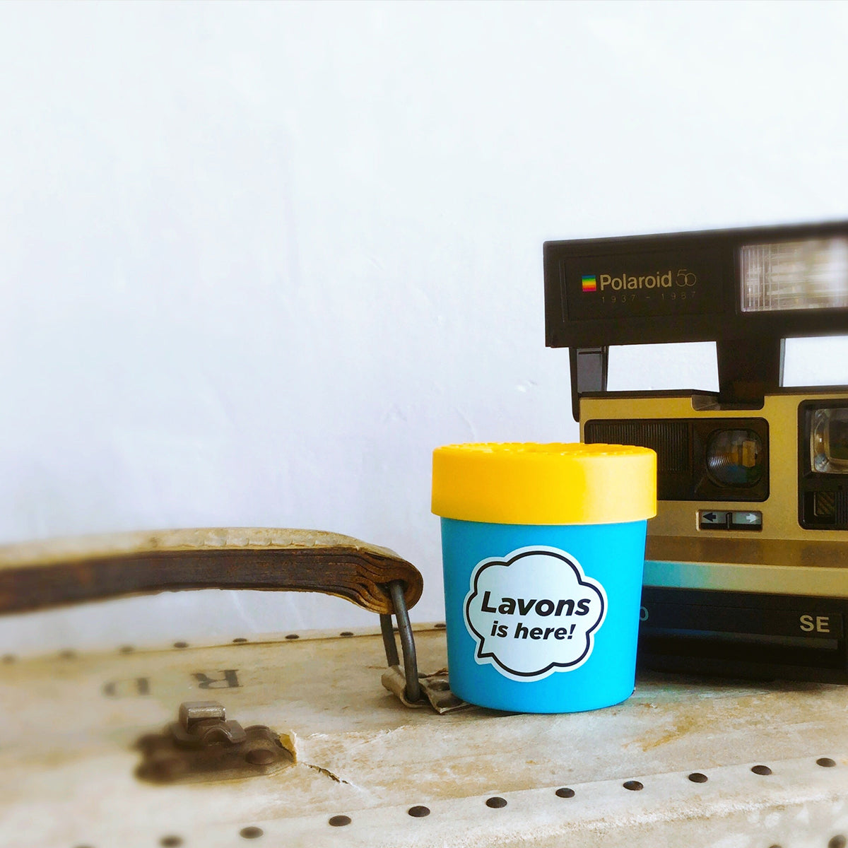 LAVONS Car Fragrance Gel Luxury Relax on top of old suit case